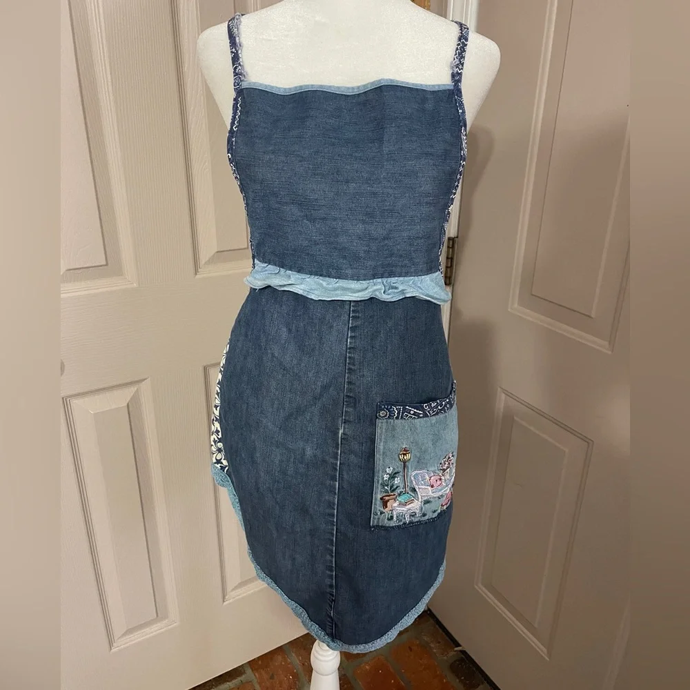Vintage medium wash light weight ruffled denim apron with embroidered pocket.